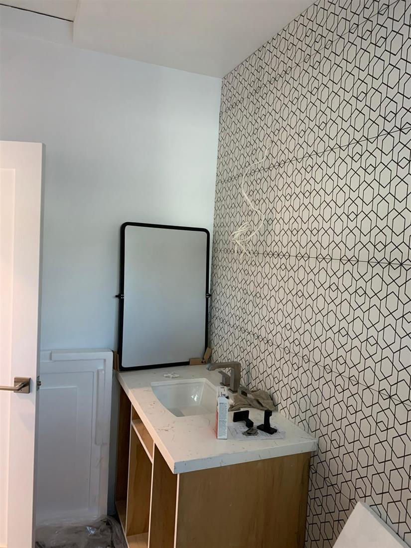 Designer powder room with patterned feature wall